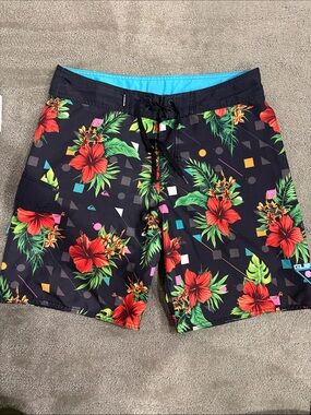 Quiksilver Black Board Shorts with Red Hibiscus and Green Foliage